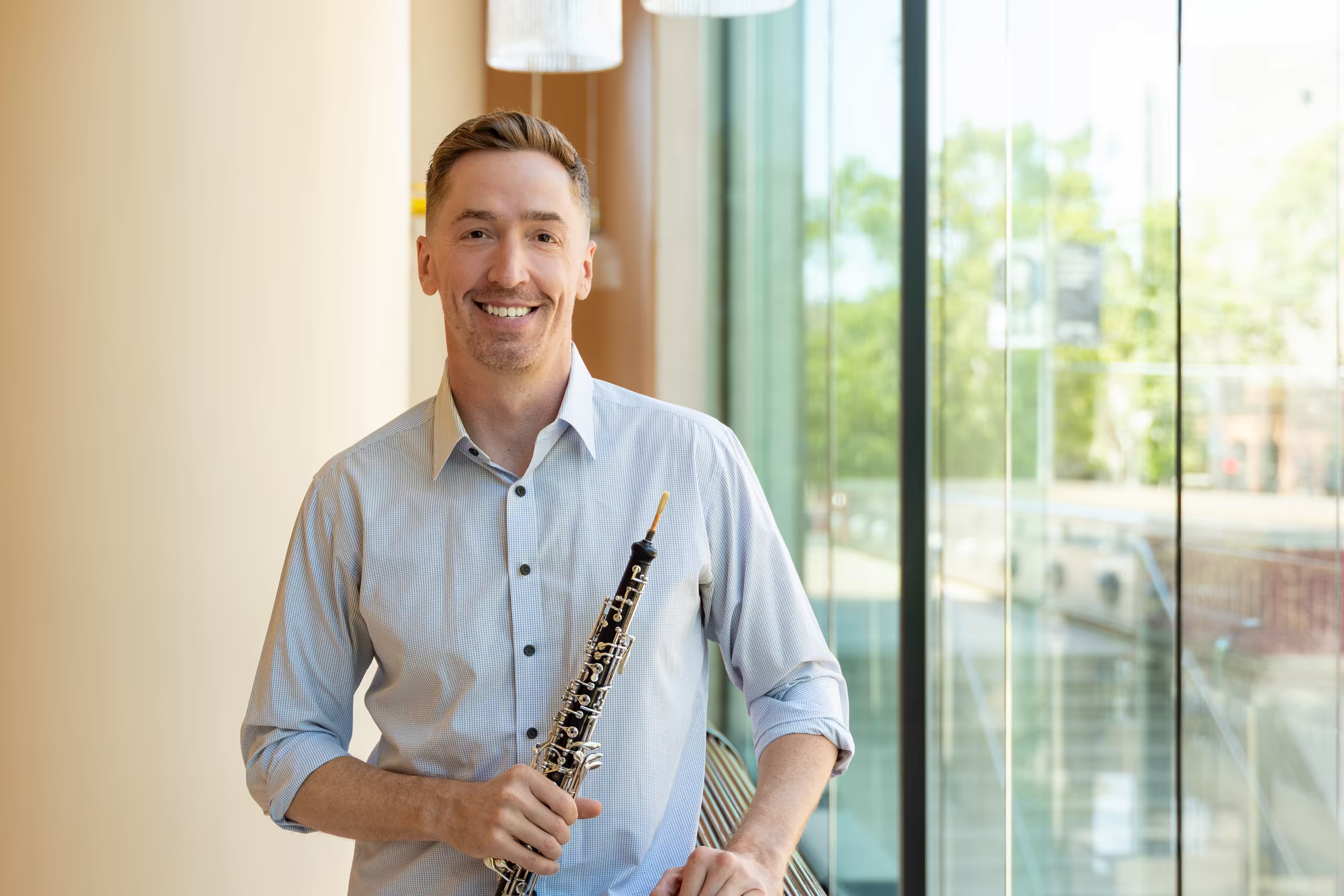 James Button holding his Marigaux 920A oboe in the lobby of Davies Symphony Hall